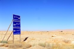 A road sign is pictured in the Badia, located in the southeast Syrian desert, June 13, 2017.