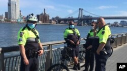 FILE - Police Officers patrol East River Park during the Coronavirus Pandemic in New York City, May 2, 2020.