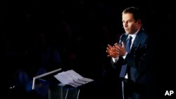 FILE - Candidate for the left-wing presidential primaries Benoit Hamon delivers a speech during a campaign rally in Paris, France, Jan. 18, 2017. Hamon's push for a "universal income" has catapulted him from obscurity to within reach of the presidency. 