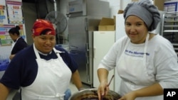 Tiffany Yanaway, 19, (r) and Katara Tyler, 17, are trainees at Sunflower Bakery, which helps people with learning disabilities find jobs in the baking industry.