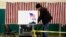 A voter marks his ballot in the first-in-the-nation presidential primary, Feb. 9, 2016, in Nashua, N.H. (AP Photo/Matt Rourke)