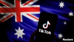 The logo of Chinese-owned video app TikTok is seen on a smartphone in front of an image of the Australian national flag in this illustration picture taken April 4, 2023. 
