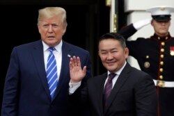 FILE - President Donald Trump greets Mongolian President Khaltmaa Battulga on the South Lawn of the White House, July 31, 2019, in Washington.