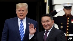 President Donald Trump greets Mongolian President Khaltmaa Battulga on the South Lawn of the White House, July 31, 2019, in Washington. 