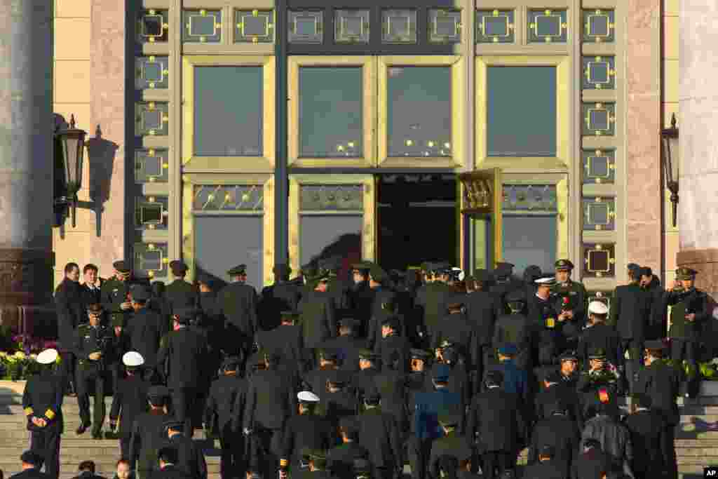 Chinese Communist Party delegates from the People's Liberation Army enter the Great Hall of the People, for the closing ceremony for the 18th Communist Party Congress, Beijing, November 14, 2012. 