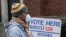 Voters masked against coronavirus line up at Riverside High School for Wisconsin's primary election, April 7, 2020, in Milwaukee. 