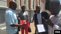 Zimbabwe journalists outside the Constitutional Court after it struck off defamation in the southern African country, Feb. 3, 2016. (Sebastian Mhofu/VOA)