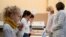 FILE - School children attend a COVID-19 saliva test in a primary school in Nice, as part of the coronavirus disease (COVID-19) testing campaign in France, March 8, 2021. 