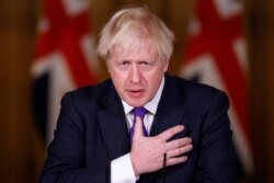 Britain's Prime Minister Boris Johnson speaks during a news conference on the ongoing situation with the coronavirus pandemic, at Downing Street in London, Wednesday December 2, 2020.