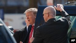 President Donald Trump steps from his motorcade vehicle as he arrives to attend service at Saint John's Church in Washington, Sunday, March 17, 2019. 