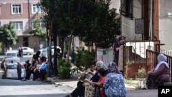 People sit and stand on the streets after evacuating their homes, following an earthquake in Istanbul, Sept. 26, 2019. 