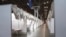 In this March 27, 2020 photo provided by Office of Governor Andrew M. Cuomo, makeshift hospital rooms stretch out along the floor at the Jacob Javits Convention Center in New York.