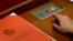 A delegate prepares to press buttons to vote on the draft resolutions during the closing session of the annual National People's Congress held in Beijing's Great Hall of the People on March 16, 2016. 