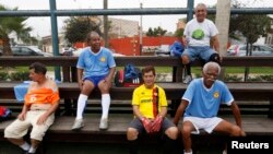 A group of senior soccer players rest after a match in Miraflores, in Lima.