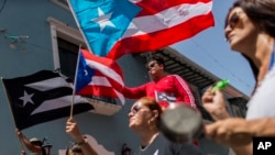 Demonstrators gather in front of the governor's mansion, La Fortaleza, in San Juan, Puerto Rico, July 24, 2019. Gov. Ricardo Rosello has faced massive calls for his resignation over obscenity-laced online chats between him and his advisers.