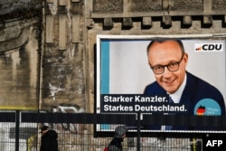 A campaign poster features a portrait of Friedrich Merz, leader of Germany's center-right Christian Democratic Union party and candidate for chancellor, in Frankfurt on Feb. 17, 2025. Merz and the Christian Democrats are leading in polls ahead of the Feb. 23 general election.