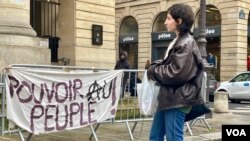 A "power to the people' sign in front of the Odeon theater, also an icon of the May 1968 protest movement.