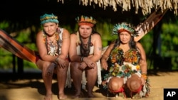 Juma Indigenous sisters Mandei Juma, from left, Mayta Juma and Borea Juma pose for a picture at their community, near Canutama, Amazonas state, Brazil, July 9, 2023. 