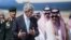FILE - U.S. Secretary of State John Kerry, left, and Saudi Foreign Minister Saud al-Faisal walk together upon Kerry's arrival at King Abdulaziz International Airport in Jeddah, Saudi Arabia.