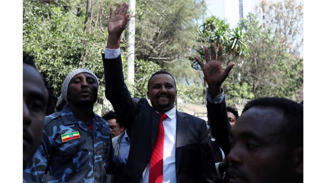 Jawar Mohammed, an Oromo activist and leader of the Oromo protest, waves to his supporters outside his house in Addis Ababa, Ethiopia, Oct. 23, 2019.