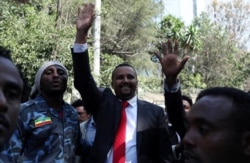 Jawar Mohammed, an Oromo activist and leader of the Oromo protest, waves to his supporters outside his house in Addis Ababa, Ethiopia, Oct. 23, 2019.