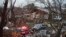 An emergency vehicle drives through a neighborhood in Rowlett, Texas, Sunday, Dec. 27, 2015.