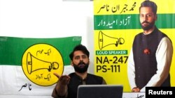 Jibran Nasir, a human rights lawyer and independent candidate for general election, gestures as he speaks at his office in Karachi, Pakistan July 23, 2018.