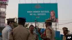 An Indian Police officer briefs his colleagues at the entrance of HITECH city, venue of the Global Entrepreneurship Summit in Hyderabad, India, Nov. 27, 2017. 