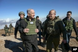 Israel's Prime Minister Benjamin Netanyahu, left, visits Israeli forces in a buffer zone inside Syria, Dec. 17, 2024.