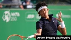 On June 8, 2021, China's Zhizhen Zhang returns a shot from Italy's Andreas Seppi during early round action of the Nottingham Open in Nottingham, Britain.