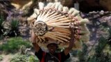A trader carries sweeping brooms for sale along the streets of Madagascar's capital Antananarivo.