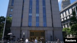 FILE - Media wait outside federal court in the Manhattan borough of New York City, New York, July 14, 2020. 