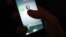 FILE - The WhatsApp and Facebook app icons are shown on an iPhone.
