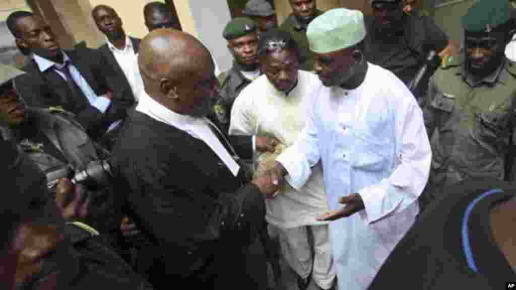 In this 2011 photo, Nigeria&#39;s former Chief security officer, Maj. Hamza Al-Mustapha, shake hands with one of his lawyers before his trial at the federal high court in Lagos.