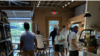 Patrons at a coffee shop in the trendy NoDa neighborhood of Charlotte, NC, wear masks. (Salim Fayeq/VOA)