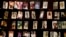 FILE - Family photographs of some of those who died hang in a display in the Kigali Genocide Memorial Centre in Kigali, Rwanda, April 2014. Officials said Rwandan Ladislas Ntaganzwa was arrested by Interpol agents in Congo, Dec. 7, 2015.