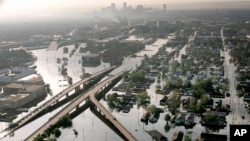 FILE - Floodwaters from Hurricane Katrina fill the streets near downtown New Orleans, Aug. 30, 2005.