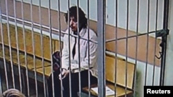 A U.S. citizen, whom the statement named as Kalob Wayne Byers, sits in a cage during a court session in Moscow, Russia, Oct. 7, 2024, in this photo taken from video released by the Moscow City Court Press Service on Feb. 15, 2025.