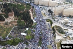 An aerial view shows protesters attending a demonstration against Israel's judicial overhaul and dismissing of the defense minister, in Jerusalem