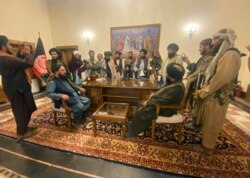 Taliban fighters take control of Afghan presidential palace after the Afghan President Ashraf Ghani fled the country, in Kabul, Afghanistan, Aug. 15, 2021.