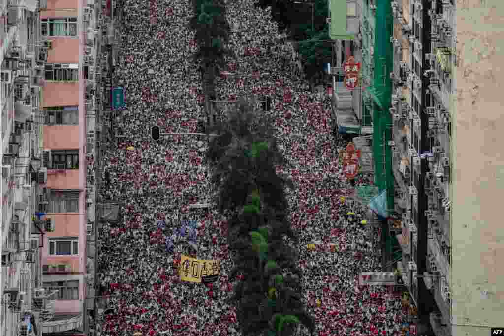 Protesters march during a rally against a controversial extradition law proposal in Hong Kong. Huge protest crowds thronged Hong Kong as anger swells over plans to allow extraditions to China, a proposal that has sparked the biggest public backlash against the city&#39;s pro-Beijing leadership in years.