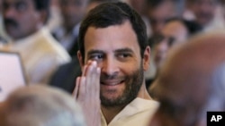 Congress party leader Rahul Gandhi greets attends the swearing-in ceremony for the new ministers in New Delhi, India, October 28, 2012. 