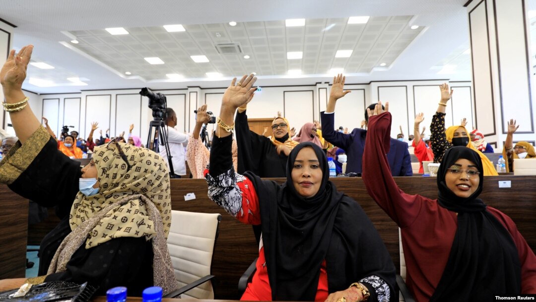 omali legislators of the lower house of parliament raise their hands to vote to extend President Mohamed Abdullahi Mohamed's term for another two years to let the country prepare for direct elections, in Mogadishu, Somalia, April 12, 2021.
