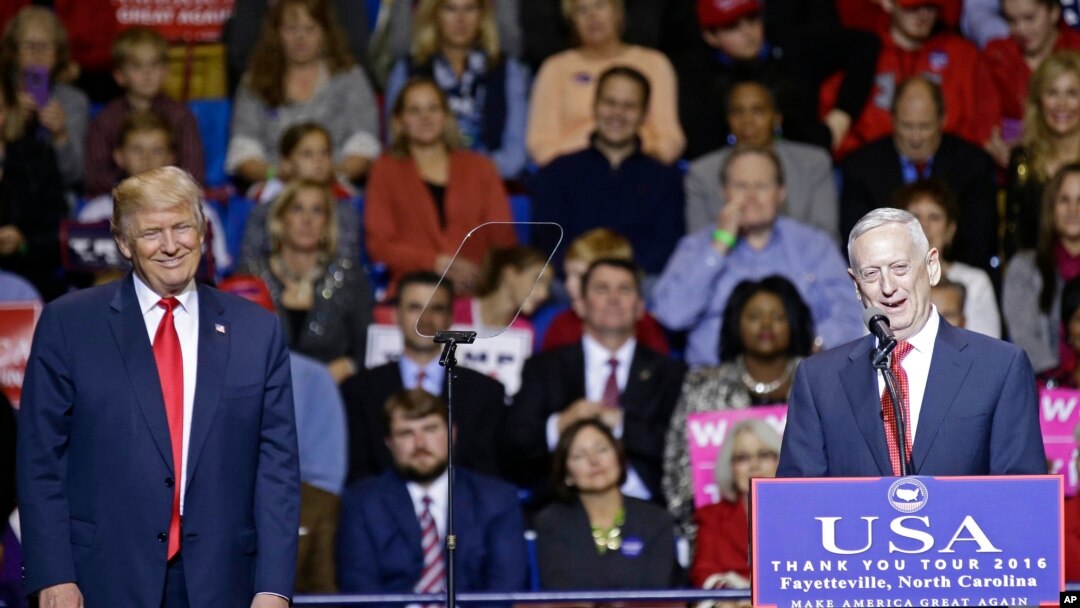 President-elect Donald Trump, left, listens to retired United States Marine Corps General James Mattis after appointing Mattis as upcoming Secretary of Defense while speaking to supporters during a rally in Fayetteville, N.C., Tuesday, Dec. 6, 2016. 
