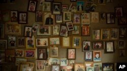 FILE - Pictures of Yazidis slain in 2014 by Islamic State militants are seen in a small room at the Lalish shrine in northern Iraq, Sept. 12, 2019.