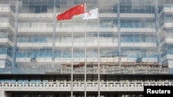 FILE - A Chinese flag flutters at the headquarters of China Development Bank in Beijing, Sept. 23, 2018.