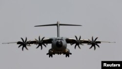 FILE - An Airbus A400M military plane flies before landing during a test flight at the airport of the Andalusian capital of Seville, May 12, 2015. 