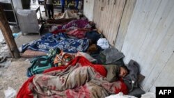 Displaced Palestinians sleep on a street in Rafah, southern Gaza Strip, April 10, 2024, amid ongoing clashes between Israel and the militant group Hamas.