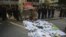 Security guards stand near protest banners and flowers are laid outside the headquarters of Southern Weekly newspaper in Guangzhou, Guangdong province January 7, 2013. 