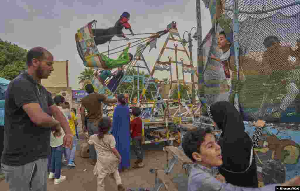 For families in Cairo, Eid includes a trip to a playground and carnival rides set up for the occasion. 